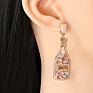 Vintage champagne bottle full of diamond-studded pearl earrings