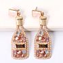 Vintage champagne bottle full of diamond-studded pearl earrings